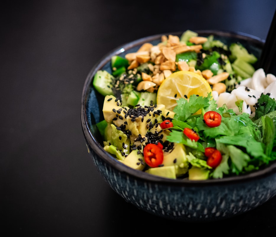 Fresh healthy ingredients including vegetables, grains, and herbs on a kitchen counter